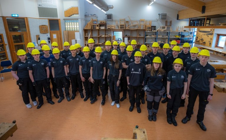 Fyrsta árs nemar í vinnufatnaði og með hjálma.