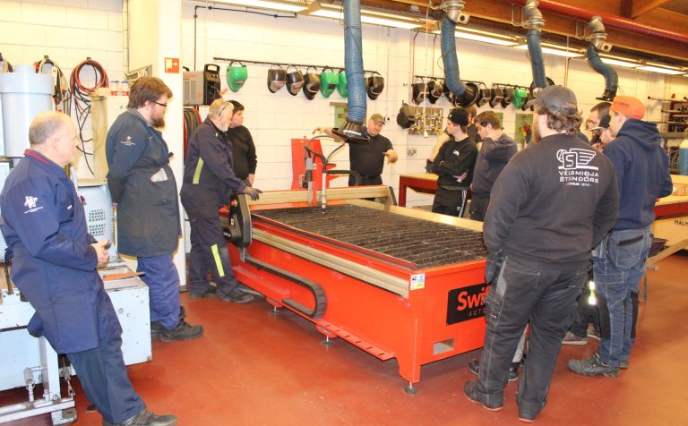 Nemendur og kennarar læra á skurðarvélina.